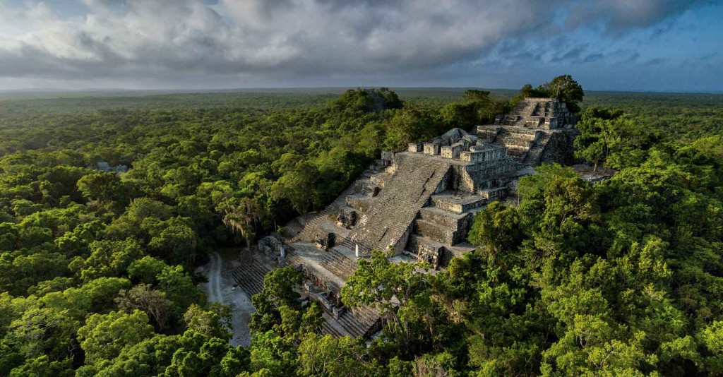 Aerial view of Structure 11 (2 ) at Calakmul, is where the body of Jaguar Paw was found by archeologist Ramon Carrasco "Structure II, which occupies the extreme south of the Grand Plaza, is a foundation of monumental proportions with a surface area of more than 100 meters (331 ft) on each side.Â  The presence of pre-Classic ceramics in unsullied deposits at an open tunnel in this building shows that its fill corresponds to that of a substructure of the late pre-Classic era.Â  Its sequence of construction preserves at least three substructures and four architectural phases:Â  the first two, assoicated with ceramics in sealed contents; the second phase corresponds to the early Classic (250-600 A.D.) era." Â Calakmul, the 'City of the Two Adjacent Pyramids', is the name given the site of one of the largest and most important cities of the lowlands of the ancientÂ  EarlyÂ hieroglyphic textsÂ fromÂ stelaeÂ found in Structure 2 record the probable enthronement of a king of Calakmul in AD 411 and also records a non-royal site ruler in 514.[26]Â After this there is a gap in the hieroglyphic records that lasts over a century, although the Kaan dynasty experienced a major expansion of its power at this time. The lack of inscriptions recording the events of this period may be either due to the fact that the Kaan dynasty was located elsewhere during this time or perhaps that the monuments were later destroyed. CALAKMUL It is located in one of the largest ecological tropical forest reservations in MÃ©xico. With approximately 723 thousand hectares, it is situated in the region of PetÃ©n, Campeche, 30 kilometers away of the Mexico-Guatemala border. This region shares with the Guatemalan PetÃ©n not only similar characteristics of flora, fauna and orography, but also an architectural style characterized by buildings erected on large basal platforms, capped with vaulted precincts. The ornamentation of structures, based on modeled and polychrome stucco, visu